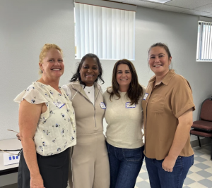 Four Springs Charter Schools staff members smiling together during a professional meeting or training session.
